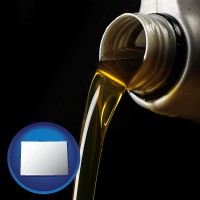 colorado pouring motor oil, on a black background