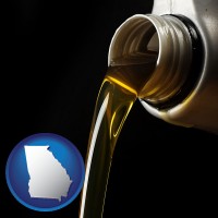 georgia pouring motor oil, on a black background