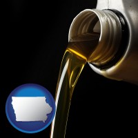 iowa pouring motor oil, on a black background