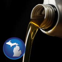 michigan pouring motor oil, on a black background