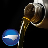 north-carolina pouring motor oil, on a black background