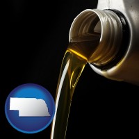 nebraska pouring motor oil, on a black background